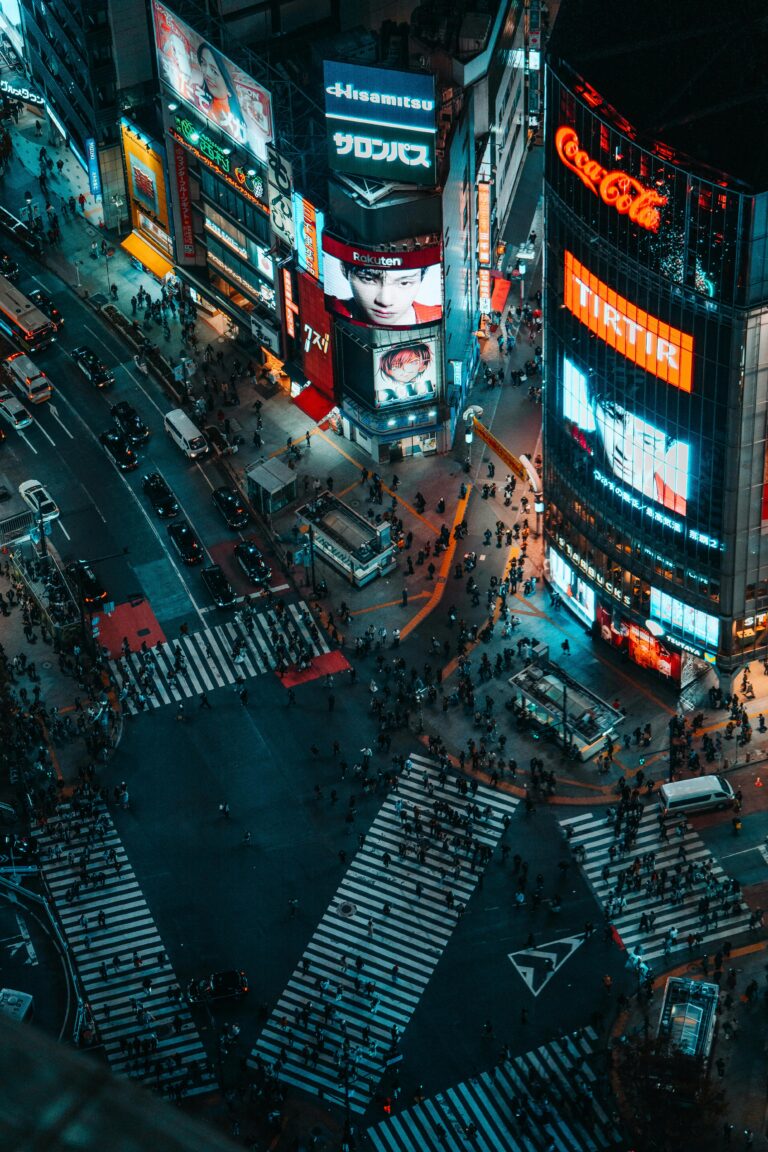 Stunning nighttime aerial photograph capturing the vibrant Shibuya Crossing in Tokyo, Japan.